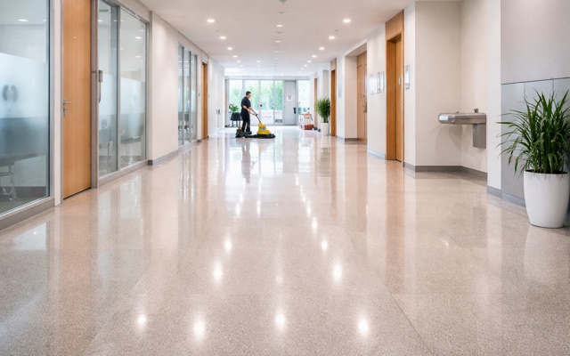 Commercial floor care with polished corridor floors and machine burnishing in progress